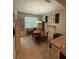 Dining area featuring a round wooden table, chandelier lighting, and adjacent kitchen access at 8271 Maritime Flag St # 109, Windermere, FL 34786