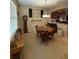 Dining area featuring a round wooden table, chandelier lighting, and adjacent kitchen access at 8271 Maritime Flag St # S, Windermere, FL 34786