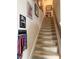 Carpeted staircase with decorative wall art and motivational sign at 8271 Maritime Flag St # S, Windermere, FL 34786