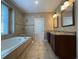 Bright bathroom with separate tub and shower, double sink vanity, and tiled floor at 907 Pawstand Rd, Celebration, FL 34747