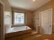 A luxurious bathroom featuring a separate shower and corner bathtub with decorative stained glass window at 907 Pawstand Rd, Celebration, FL 34747
