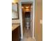 Cozy water closet featuring tiled flooring, a white toilet, and a dark brown cabinet at 907 Pawstand Rd, Celebration, FL 34747