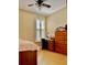 Bedroom featuring desk and dresser, ideal for and teens, with natural light through window at 907 Pawstand Rd, Celebration, FL 34747