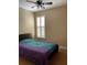 Bedroom with light-colored walls and floors featuring a queen-size bed and plantation shutters at 907 Pawstand Rd, Celebration, FL 34747