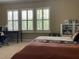 Comfortable bedroom featuring lots of natural light from the shuttered windows, and a desk at 907 Pawstand Rd, Celebration, FL 34747