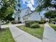 Charming two-story home with white siding, front porch, and well-maintained landscaping at 907 Pawstand Rd, Celebration, FL 34747
