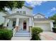 Charming two-story home with a welcoming front porch and a red front door at 907 Pawstand Rd, Celebration, FL 34747