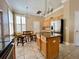 Bright kitchen featuring an island with granite countertops and stainless steel refrigerator at 907 Pawstand Rd, Celebration, FL 34747