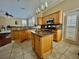 Open kitchen with central island, tile backsplash and stainless steel appliances at 907 Pawstand Rd, Celebration, FL 34747
