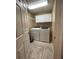 Bright laundry room featuring tile floors, a wire rack, and overhead cabinets for optimal storage at 907 Pawstand Rd, Celebration, FL 34747