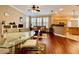 Inviting living room featuring hardwood floors, plantation shutters, and an open floor plan to the kitchen at 907 Pawstand Rd, Celebration, FL 34747