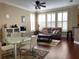 Comfortable living room featuring hardwood floors, a ceiling fan, and bright natural light at 907 Pawstand Rd, Celebration, FL 34747