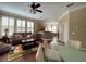 Cozy living room with a view into the kitchen, hardwood floors, and plantation shutters at 907 Pawstand Rd, Celebration, FL 34747