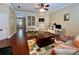 Cozy living room with hardwood floors, stylish furnishings, and decorative built-in shelving at 907 Pawstand Rd, Celebration, FL 34747