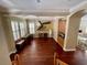Living room with hardwood floors, built-in storage, plantation shutters, and modern art at 907 Pawstand Rd, Celebration, FL 34747