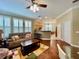 Inviting living room features hardwood floors, large windows with plantation shutters, and seamless access to the kitchen at 907 Pawstand Rd, Celebration, FL 34747
