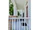 Inviting front porch with brick accents and columns, leading to a red front door at 907 Pawstand Rd, Celebration, FL 34747