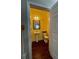 Features a pedestal sink, toilet, hardwood floors and yellow painted walls providing charm and functionality at 907 Pawstand Rd, Celebration, FL 34747