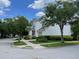 Corner lot featuring a white, two-story home with lush landscaping and sidewalk access at 907 Pawstand Rd, Celebration, FL 34747