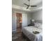 Bright bedroom featuring a ceiling fan, decorative ceiling and ensuite bath at 9938 Eagle Creek Center Blvd, Orlando, FL 32832