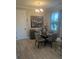 Cozy dining area features a modern chandelier and round table with seating for four at 9938 Eagle Creek Center Blvd, Orlando, FL 32832
