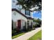 Charming two-story home with a red front door and stone accents, offering appealing curb appeal at 9938 Eagle Creek Center Blvd, Orlando, FL 32832