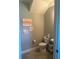 The half bath has ceramic tile floors and artwork on the wall at 9938 Eagle Creek Center Blvd, Orlando, FL 32832