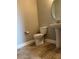 Cozy half-bathroom with a pedestal sink and tile flooring, offering a functional and stylish space at 9938 Eagle Creek Center Blvd, Orlando, FL 32832