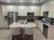 Modern kitchen boasts stainless steel appliances, white cabinets and a center island with seating at 9938 Eagle Creek Center Blvd, Orlando, FL 32832