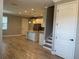 Open-concept living and kitchen area with tile floors and modern lighting, perfect for entertaining guests at 9938 Eagle Creek Center Blvd, Orlando, FL 32832