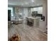 Open-concept living room with tile floors and a kitchen island with barstool seating at 9938 Eagle Creek Center Blvd, Orlando, FL 32832