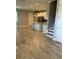 Spacious living area with tile flooring that flows into a modern kitchen with stainless steel appliances at 9938 Eagle Creek Center Blvd, Orlando, FL 32832