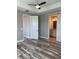 Well-lit main bedroom with a modern ceiling fan and barn door to bathroom, creating a relaxing retreat at 9938 Eagle Creek Center Blvd, Orlando, FL 32832