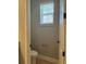 Compact powder room features a toilet and window at 9938 Eagle Creek Center Blvd, Orlando, FL 32832