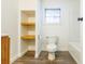 Bathroom with open shelving, toilet and shower tub at 1007 11Th St, St Cloud, FL 34769