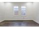 Bright bedroom with hardwood floors and two windows providing natural light at 1007 11Th St, St Cloud, FL 34769