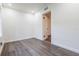 Clean bedroom featuring gray wood floors, fresh paint and an open door at 1007 11Th St, St Cloud, FL 34769