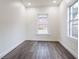 Freshly painted bedroom featuring laminate flooring and large windows for natural light at 1007 11Th St, St Cloud, FL 34769