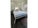 Cozy bedroom with a comfortable bed, natural light, and dark wood-look flooring, creating a relaxing atmosphere at 1007 11Th St, St Cloud, FL 34769