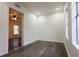 Cozy bedroom featuring gray wood floors and view into the living room at 1007 11Th St, St Cloud, FL 34769