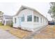 Charming home featuring a new paint job, blue door, landscaping, and well-maintained lawn at 1007 11Th St, St Cloud, FL 34769