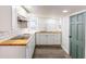 Well lit kitchen featuring white cabinets and wood countertops at 1007 11Th St, St Cloud, FL 34769