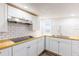 Well-lit kitchen features white cabinets, subway tile backsplash, and modern stainless-steel fixtures at 1007 11Th St, St Cloud, FL 34769