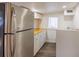 Modern kitchen featuring stainless steel fridge, white cabinets and wood countertops at 1007 11Th St, St Cloud, FL 34769