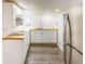 Modern kitchen featuring white cabinets, wood countertops, and stainless steel appliances at 1007 11Th St, St Cloud, FL 34769