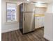 Open kitchen area featuring stainless steel refrigerator and white cabinets with butcher block countertops at 1007 11Th St, St Cloud, FL 34769