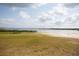 Scenic view of lakefront property with grassy lawn extending to tranquil water at 1007 11Th St, St Cloud, FL 34769