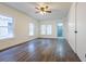 Bright living room with laminate flooring, updated fan, and freshly painted walls at 1007 11Th St, St Cloud, FL 34769
