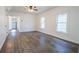 Spacious living room with new laminate floors, ceiling fan, and natural light at 1007 11Th St, St Cloud, FL 34769