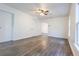 Expansive living area featuring new flooring, fan, and neutral paint at 1007 11Th St, St Cloud, FL 34769